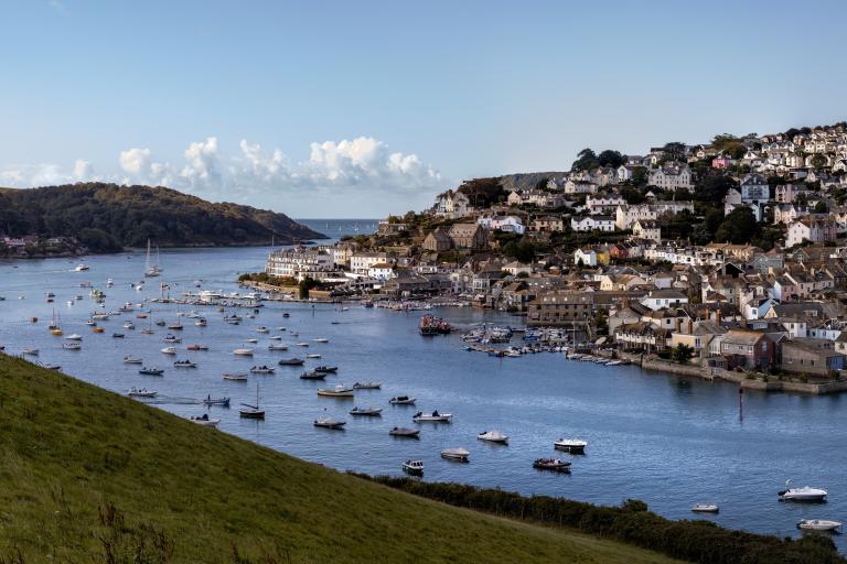 A photo of Salcombe Estuary and Town, as viewed from Snapes Point on a sunny day, with bright blue skies.