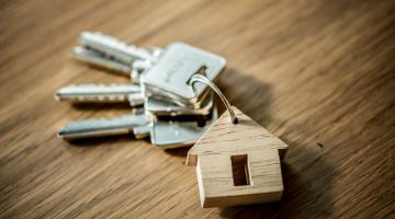 silver house keys with wooden house keyring 