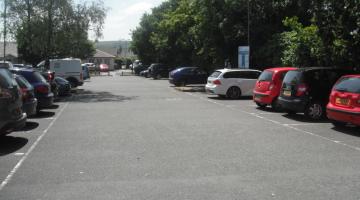 Cars parked in Leonard's Road car park, Ivybridge on a sunny day in the summer.